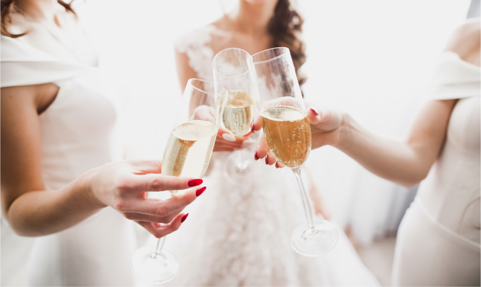 members of the bridal party cheering with champagne