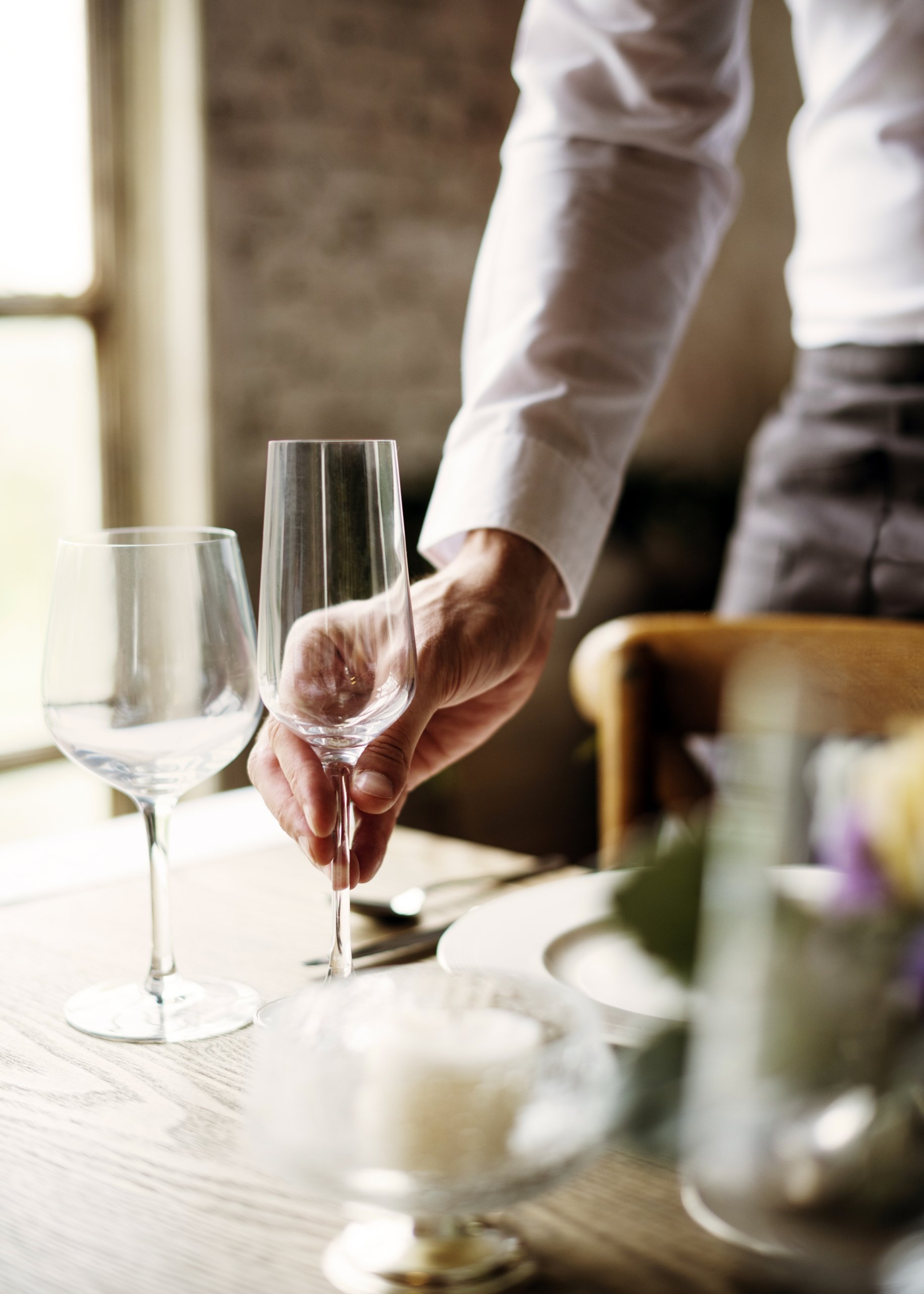 A waiter setting a table